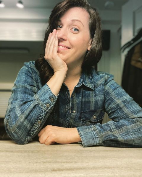 Allison Tolman in a green shirt poses for a picture.