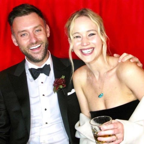 Cooke Maroney in a black tuxedo poses a picture with wife Jennifer Lawrence.
