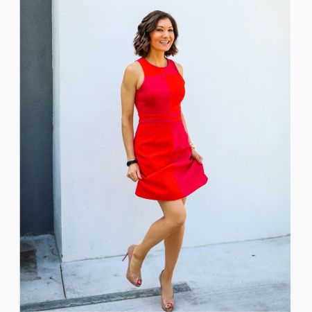 Liberte Chan in a red dress poses for a picture.
