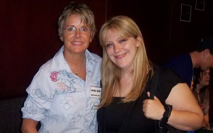 Carrie Schenken and Amanda Bearse pose for a picture.