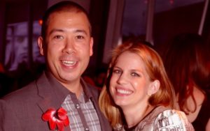 Shaun So in a grey shirt poses with Anna Chlumsky.