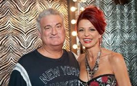 Evanka Franjko in red dress poses with husband Joey Buttafuoco.