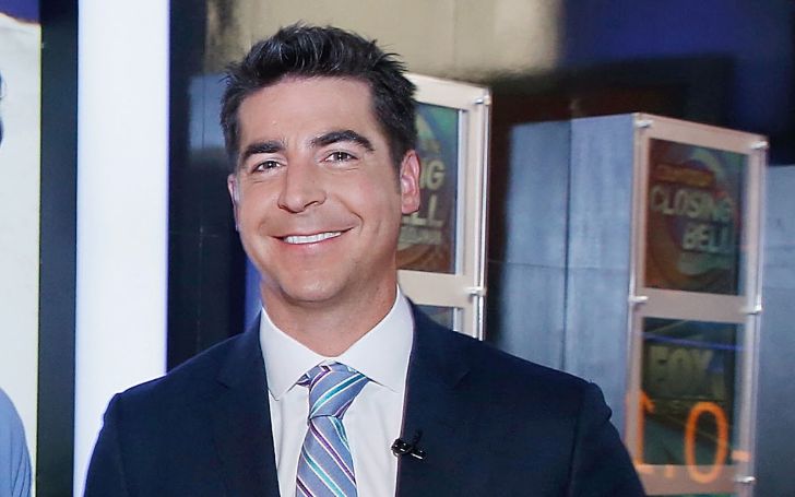 Jesse Watters in a black suit poses for a picture.
