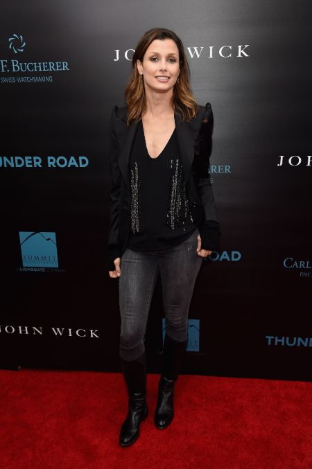 Bridget Moynahan in a black pant and shirt poses at the premiere of John Wick.