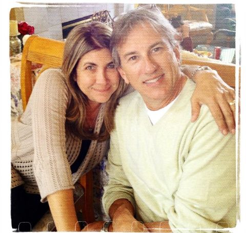 Mark Wallengren in a white t-shirt poses with wife.