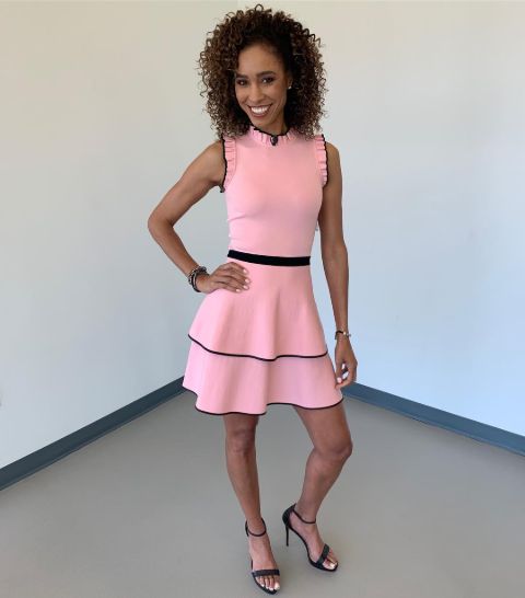 Sage Steele in a pink dress poses for a picture.