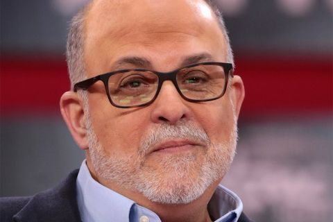 Mark Levin in a black coat poses for a picture.