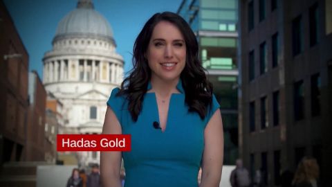 Hadas Gold in a blue dress reporting for CNN.