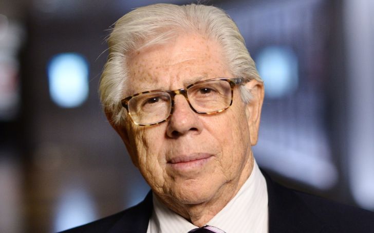 Carl Bernstein in a black suit poses for a picture.