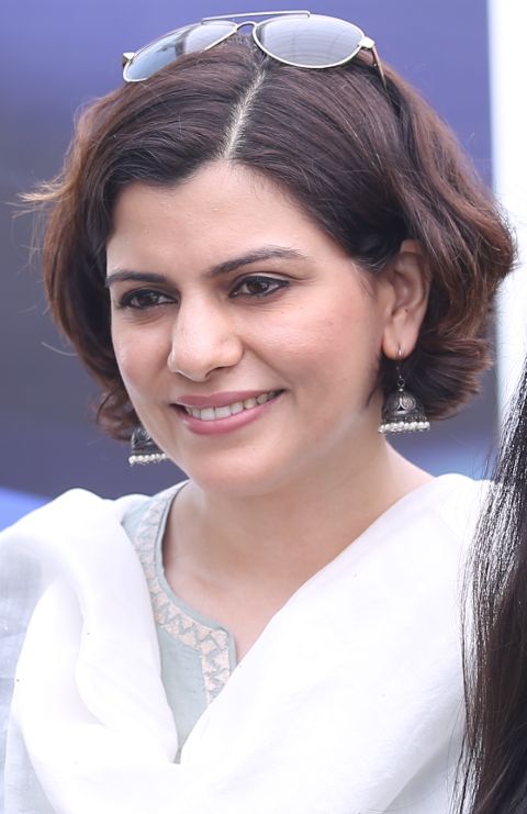 Nidhi Razdan in a white dress poses for a picture.
