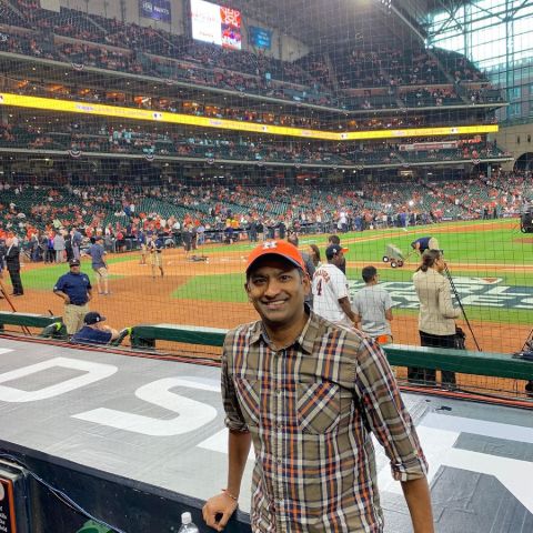 Shanel Pratap in a brown shirt poses for a picture at a stadium.