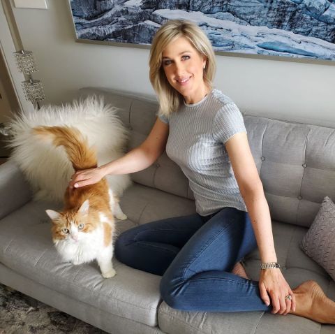 Anne Drewa poses a picture with her dog in her couch.