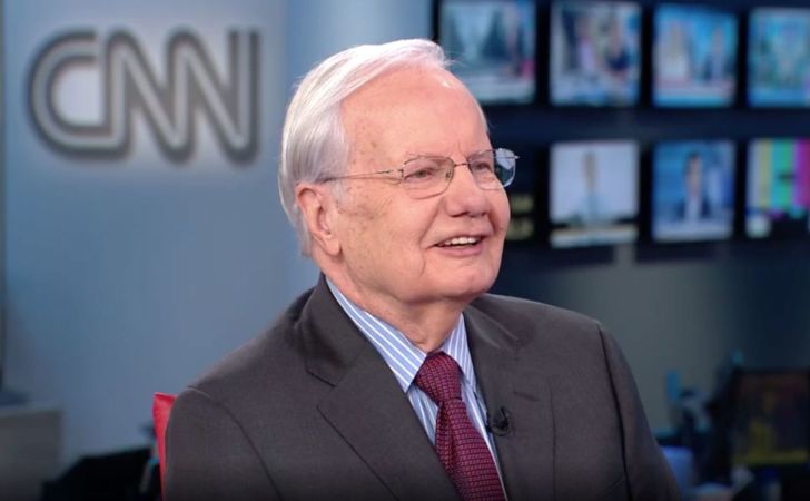 Bill Moyers in a black suit caught in the camera.
