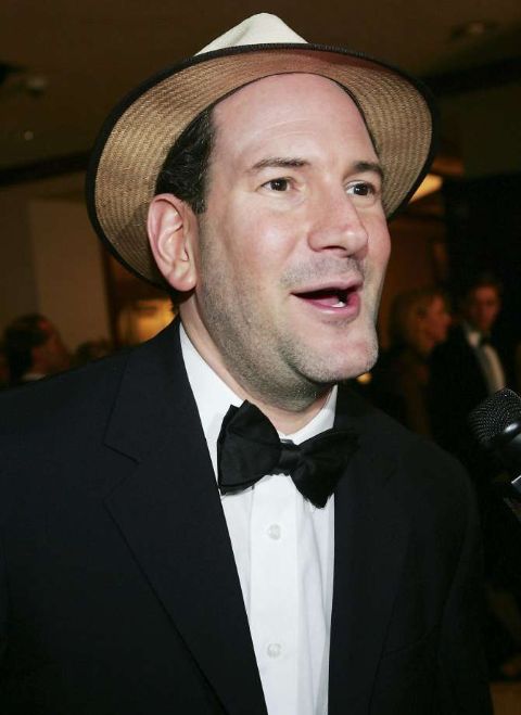 Matt Drudge in a black tux and a white hat poses for a picture.