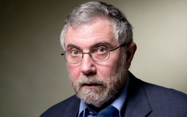 Paul Krugman in a black suit poses for a picture.