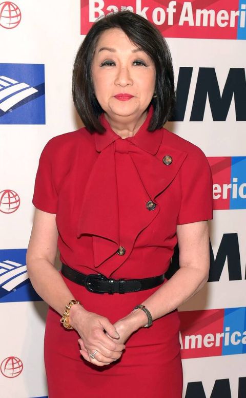 Connie Chung in a red dress poses for a picture.