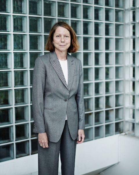 Jill Abramson in a grey coat poses for a picture.