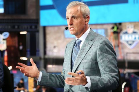 Trey Wingo in a grey suit caught in the camera.