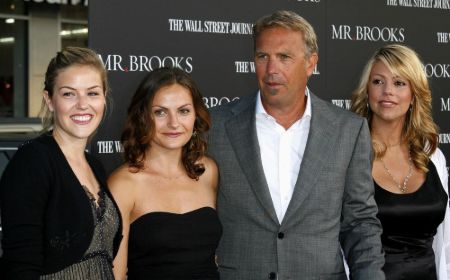 Christine Baumgartner poses a picture with Kevin Costner and their colleagues..